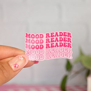 May include: Pink sticker sheet with the words "Mood Reader" repeated five times in a pink, bubble-like font.