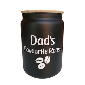 May include: Black coffee canister with a bamboo lid. The canister has white text that reads "Dad's Favourite Roast" and a graphic of three coffee beans.