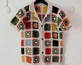 May include: A short-sleeved crochet shirt with a button-up front. The shirt is made of a patchwork of colorful squares in shades of red, green, blue, yellow, and orange.
