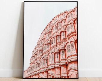 May include: A framed photograph of a pink building with many windows and arches. The building is a popular tourist destination in India.