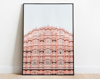 May include: A photograph of the Hawa Mahal, a palace in Jaipur, India. The palace is made of pink sandstone and has a unique honeycomb-like facade with many windows.