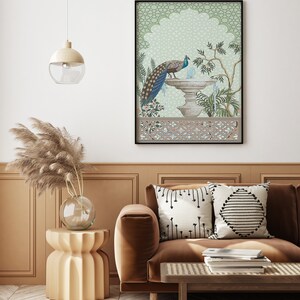 May include: A brown velvet sofa with two throw pillows, one with a black and white geometric pattern and the other with a black and white diamond pattern. A wooden coffee table with a woven top sits in front of the sofa. A framed print of a peacock standing on a fountain in a green and white garden hangs on the wall behind the sofa.