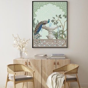 May include: A framed print of a peacock standing by a fountain in a green and brown garden with a decorative archway. The print has a green background with a geometric pattern.