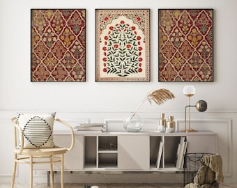 May include: Three framed prints with a red, white, and green color scheme. The center print features a stylized tree with red flowers and green leaves. The prints are hanging on a white wall above a white shelf with a vase, books, and a basket.