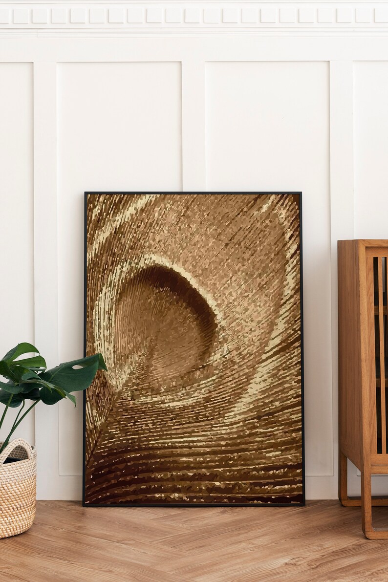 May include: A framed abstract art print with a brown and beige color scheme. The print features a swirling, circular pattern that resembles a tunnel or vortex.