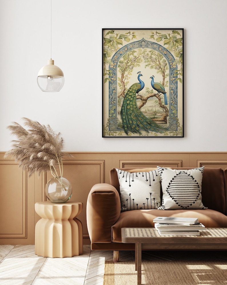 May include: A framed vintage illustration of two peacocks perched on a branch in a garden setting. The peacocks are depicted in shades of blue, green, and gold, with intricate details in their feathers. The background features a decorative archway and lush foliage.