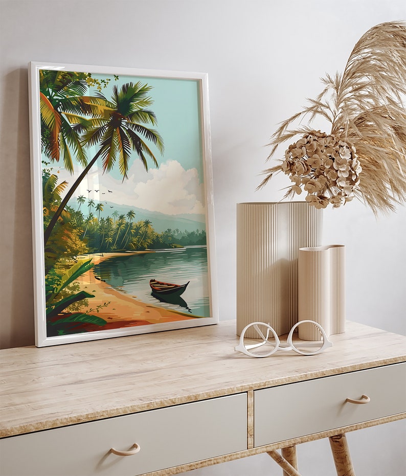 May include: A framed print of a tropical beach scene with palm trees, a sandy shore, and a small boat in the water. The print is in a white frame and is hanging on a wall.