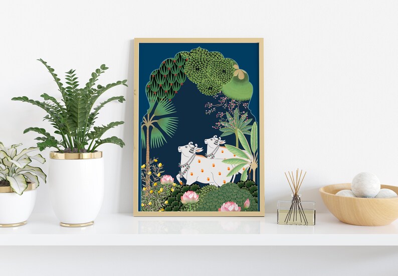 May include: A framed illustration of two white cows with orange spots walking through a lush green forest. The background is a deep blue color with a golden archway.