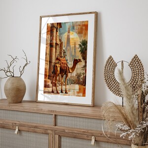 May include: A framed print of a camel standing in front of a building with a sunset in the background.