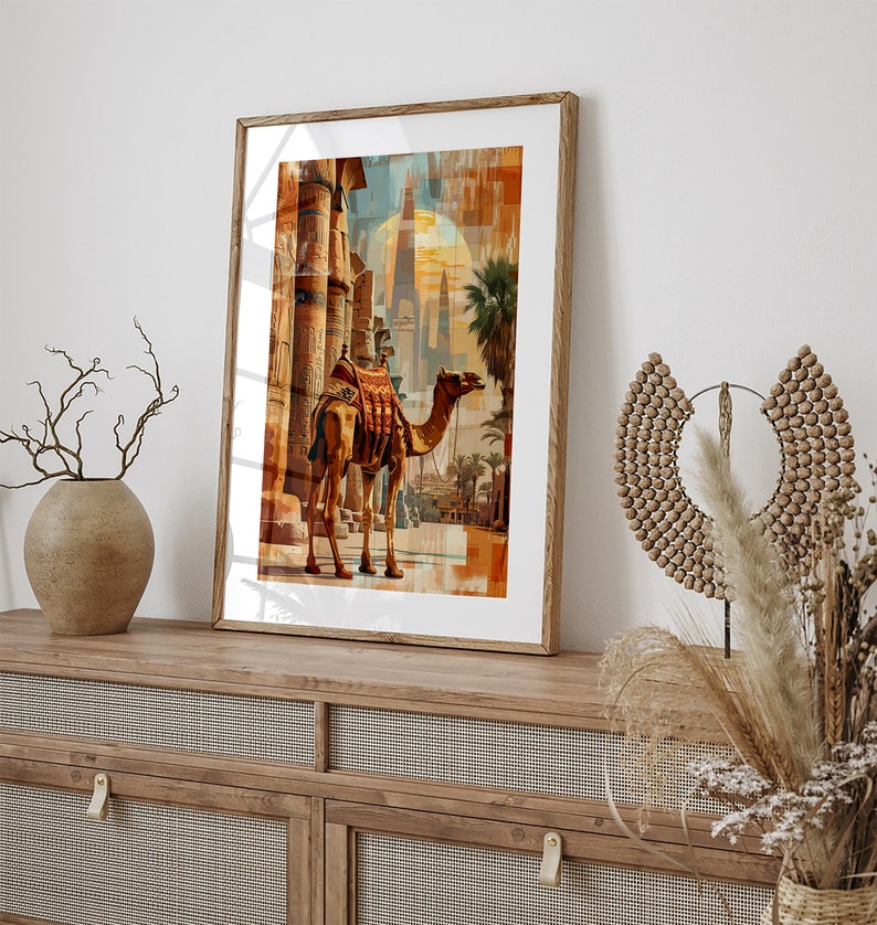 May include: A framed print of a camel standing in front of a building with a sunset in the background.
