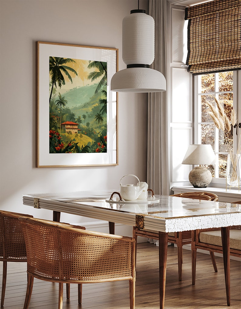May include: A dining room with a white table and chairs, a white pendant light, and a framed print of a tropical landscape with a house in the distance.