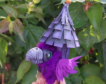 Purple baba yaga crow hut sculpture