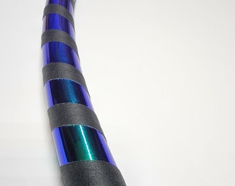 May include: A blue and green iridescent hoop with black tape wrapped around it. The hoop is bent into a slight arc.