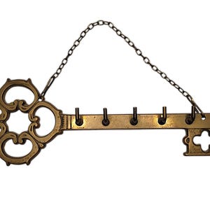 Antique brass keychain with floral ornament, keychain for collectors and home decoration.