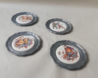 Antique pewter coasters with porcelain inlay and harvest motifs - decorative and functional collectibles
