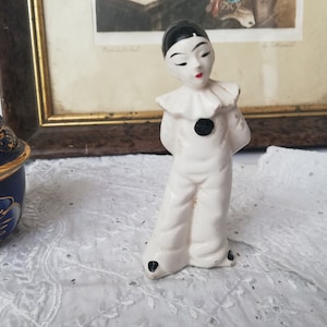 Little Pierrot boy with hands behind his back, vintage