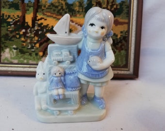 Porcelain figure with little girl and toys, vintage from Germany