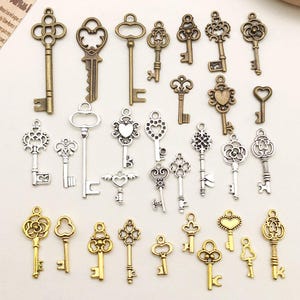 May include: A selection of antique-style keys in different sizes and designs. The keys are in gold, silver, and bronze tones, with intricate detailing. Some keys have heart and floral patterns, suitable for jewellery making or craft projects.