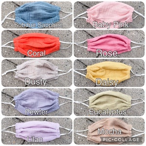 May include: A collage of 10 different colored fabric face masks. The colors are: Subdue Sapphire, Baby Pink, Coral, Rose, Dusty, Daisy, Pewter, Eucalyptus, Lilac, and Mocha.