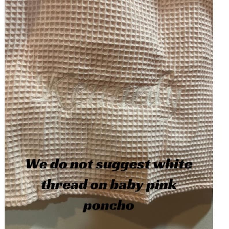 May include: A close-up of a pale pink waffle weave fabric with white embroidery. The text "We do not suggest white thread on baby pink poncho" is visible at the bottom of the image.