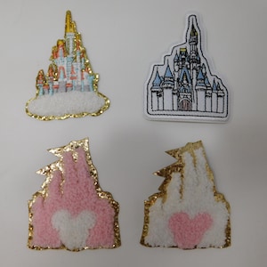 May include: Four embroidered patches featuring castle designs. Two patches depict detailed castles with multiple colors, while the other two show simplified castle silhouettes with a heart shape. All patches have gold trim.