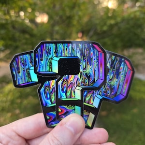 May include: A hand holds three holographic stickers. Each sticker is a stylized letter "P" with a black center and a colorful, swirling design. The stickers have a rainbow sheen and the text "@PSYCHEDELICDERHOUSE" is printed on the edge.