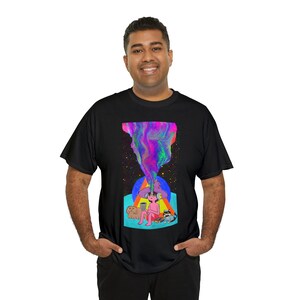 May include: A black t-shirt featuring a colourful graphic print of a person wearing a hat and sitting with two animals. The graphic has a swirling, psychedelic design.