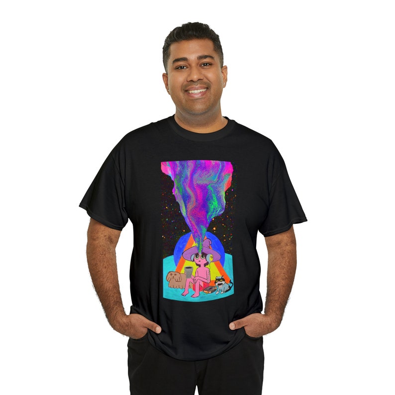 May include: A black t-shirt featuring a colourful graphic print of a person wearing a hat and sitting with two animals. The graphic has a swirling, psychedelic design.
