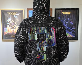 May include: A black hooded sweatshirt featuring a repeating white wavy line pattern across the entire garment. The back displays a large, central question mark graphic filled with a vibrant, multi-colored, swirling liquid-like design.