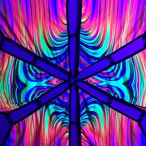 May include: A colorful, psychedelic canopy made of six panels of fabric with a black trim. The fabric is a swirling pattern of neon pink, green, blue, and black.