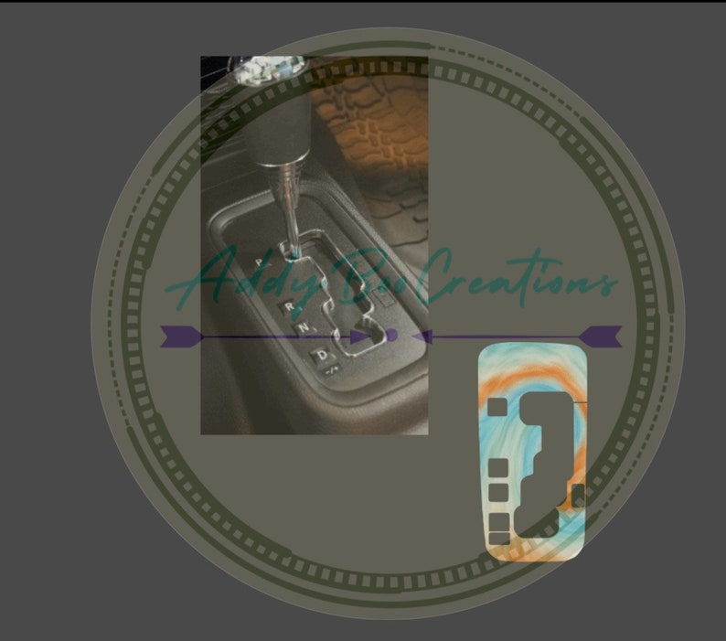May include: A close-up of a car's gear shift lever with a custom gear shift knob. The knob is made of a light blue, orange, and white swirl pattern.