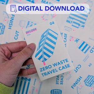 May include: A white card with the text "ZERO WASTE TRAVEL CASE" and a blue and white striped illustration of a travel case. The card is held in a hand and has the text "DIGITAL DOWNLOAD" at the top.
