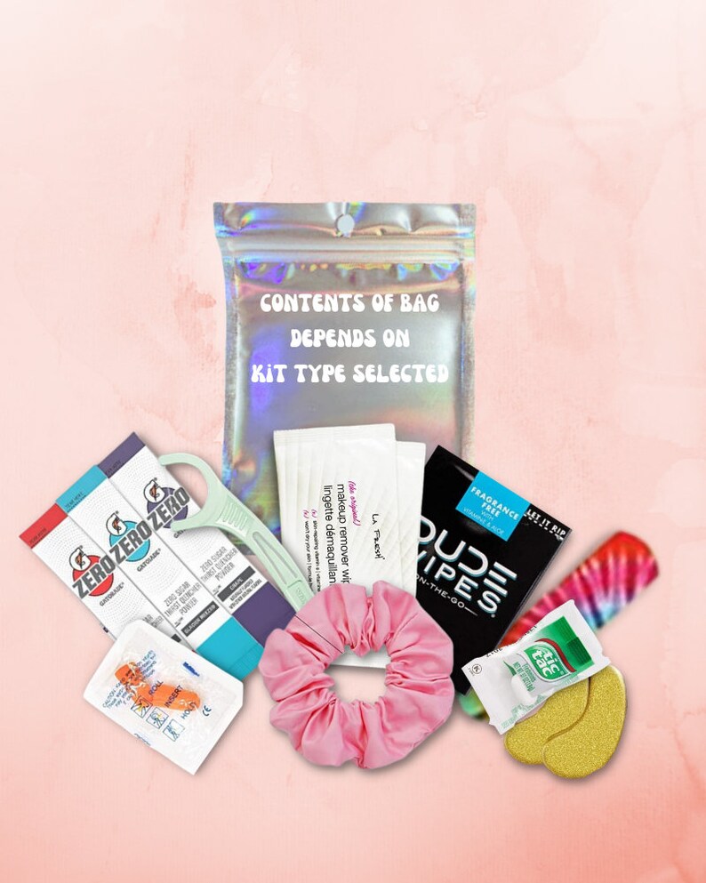 May include: A pink iridescent bag with the text "CONTENTS OF BAG DEPENDS ON KIT TYPE SELECTED". The bag contains various items, including makeup remover wipes, hair ties, eye masks, and a travel-sized deodorant.