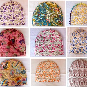 May include: Nine different patterned tea cozy covers. The covers are made of fabric and have a variety of colors and designs, including floral, paisley, and geometric patterns.