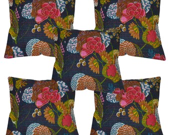 May include: Five square throw pillows with a dark blue background and a floral pattern. The flowers are in shades of pink, red, orange, and yellow. The pillows have a quilted texture.