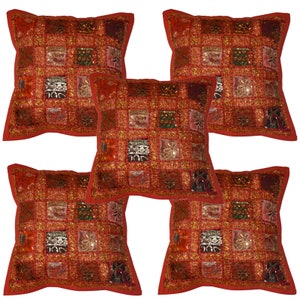 May include: Set of five red square cushion covers with a patchwork design featuring gold and silver sequins and embroidery.
