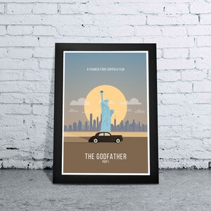 May include: A black framed poster with a minimalist design featuring the Statue of Liberty, a cityscape, and a black car. The poster has the text "A Francis Ford Coppola Film" and "The Godfather Part I".