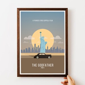 May include: A minimalist poster design for The Godfather Part I movie. The poster features a black car driving in front of the Statue of Liberty with the New York City skyline in the background. The text "A Francis Ford Coppola Film" and "The Godfather Part I" are printed on the poster.