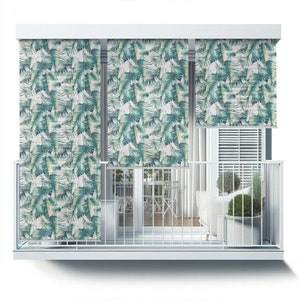 May include: White balcony with a white railing and three white window shades with a tropical leaf pattern. The shades are pulled down and the balcony is empty except for a white sofa and a potted plant.