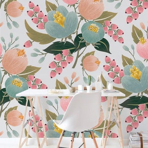 May include: A white desk with a white chair in front of it. The wall behind the desk is covered in a floral wallpaper with pink, blue, and green flowers. The text "Marzipan Days" is written in black at the bottom of the image.