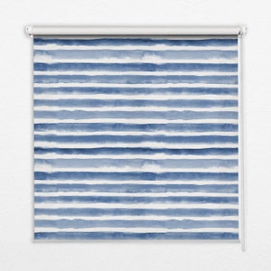 Op de afbeelding: Een witte rolgordijn met een blauw aquarel streepdessin. De strepen zijn horizontaal en hebben een vervaagde, gewassen look.