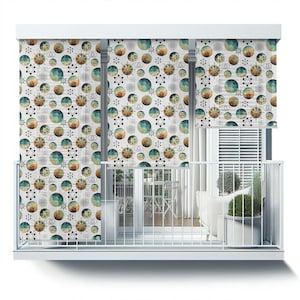 May include: A balcony with white railings and a white wall. The wall is covered with a patterned window shade featuring a geometric design with circles and stars in shades of brown, green, and blue.