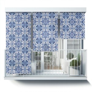 May include: White balcony with a white railing and three blue and white patterned window shades. The shades have a geometric design with blue floral patterns on a white background.