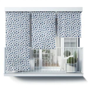 May include: White balcony with a white railing and three blue and white patterned roller shades. The shades have a watercolor-style design with blue circles on a white background. The balcony has a white floor and a white ceiling.