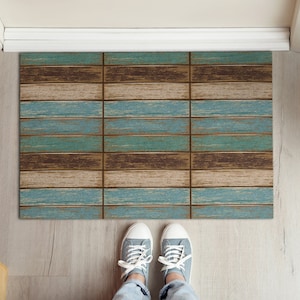 May include: A blue and brown doormat with a wood plank design. The doormat is made of a durable material and is perfect for high-traffic areas.