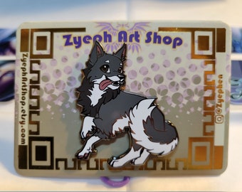 May include: A black and white enamel pin featuring a cartoon wolf with a tongue sticking out. The pin is on a white background with a gold border and the text "Zyeoh Art Shop" in purple.