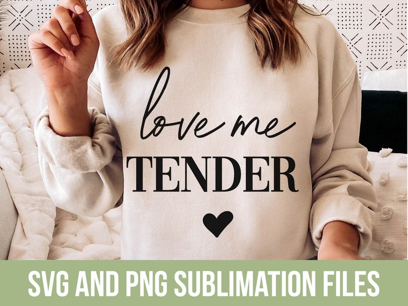 May include: A white sweatshirt with the text "love me tender" in black lettering and a small black heart below the text.