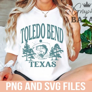 May include: White t-shirt with a teal graphic featuring the words "TOLEDO BEND TEXAS" above an illustration of a fish jumping out of the water, with trees on either side. The words "PNG AND SVG FILES" are at the bottom.