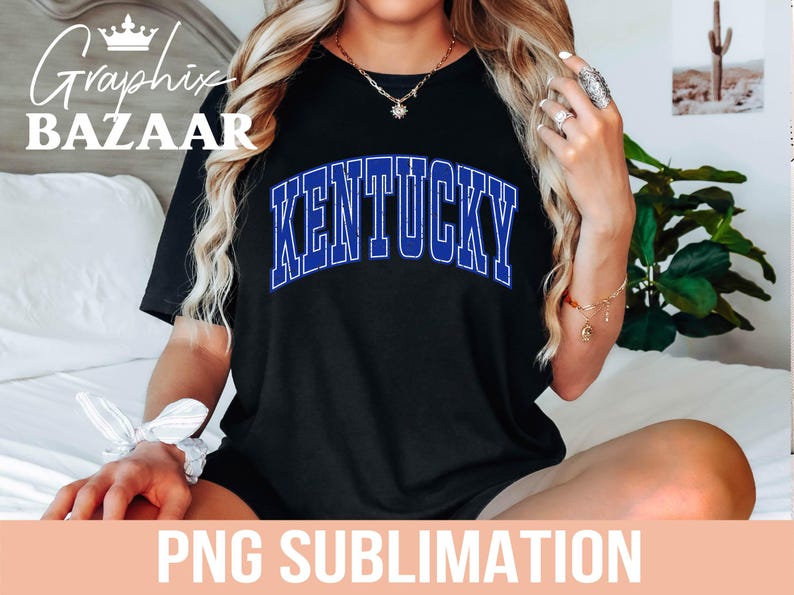 May include: Black t-shirt with the word "KENTUCKY" in blue, outlined in white. The text is arched across the front of the shirt. The image also includes the text "PNG SUBLIMATION" at the bottom.