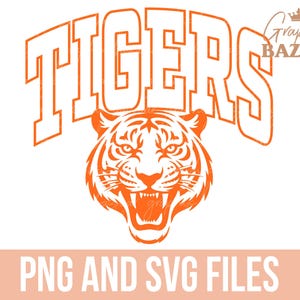 May include: Orange graphic design featuring the word "TIGERS" in bold, arched letters above a detailed tiger head with an open mouth. The image includes the text "PNG AND SVG FILES" at the bottom.